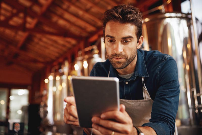 A business owner looking at a calculator on his ipad