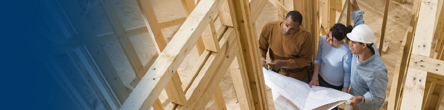 A woman looking at her blueprints of her new home