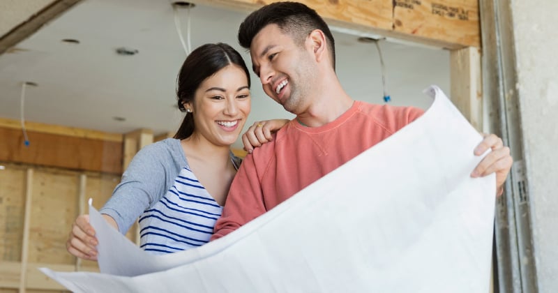 A couple looking at plans for their renovation